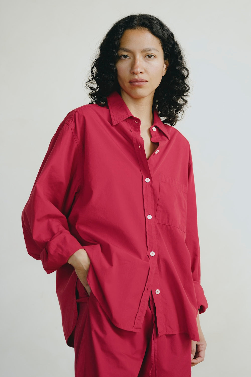 Person wearing a red outfit against a plain background